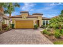 Charming single-story home with a tile roof, brick driveway, two-car garage, and lush landscaping at 12711 Del Corso Loop, Bradenton, FL 34211