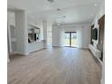Spacious living room with tile flooring and sliding glass doors for plenty of natural light at 1541 Music Ln, North Port, FL 34286