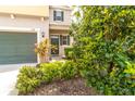 Beautiful landscaping surrounds the entryway of this lovely two-story home with a convenient attached garage at 1570 Ludington Ave, Wesley Chapel, FL 33543