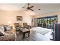Spacious living room with ceiling fan and sliding glass doors leading to the pool at 18422 Burkholder Cir, Port Charlotte, FL 33948