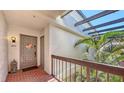 Welcoming condo entrance with brick floor, stylish decorations, and tropical plants at 1935 Gulf Of Mexico Dr # G7-402, Longboat Key, FL 34228