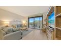 Bright living room featuring comfortable seating and access to the screened lanai at 1935 Gulf Of Mexico Dr # G7-402, Longboat Key, FL 34228