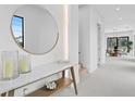 Bright foyer featuring marble top console table with decor and a round mirror at 2249 Oak Terrace St, Sarasota, FL 34231