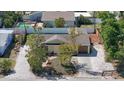 View of home with mature trees, gravel landscaping, and neutral color palette at 2316 Bradford St, Sarasota, FL 34231