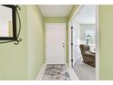 Welcoming entryway with tile flooring, light green walls, and view into the living room, creating an inviting space at 2912 Fiddlers Bnd, Palmetto, FL 34221