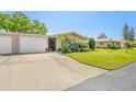 Beautiful single-story home with a lush lawn and attached two-car garage on a sunny day at 3328 Dartmouth Ln # 1012, Sarasota, FL 34239
