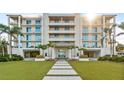 Stunning condo building with balconies, lush landscaping, and a beautiful entrance, perfect for luxurious coastal living at 4765 Gulf Of Mexico Dr # B202, Longboat Key, FL 34228