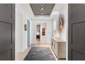Elegant hallway features a designer ceiling, modern lighting, and stylish decor at 4765 Gulf Of Mexico Dr # B202, Longboat Key, FL 34228