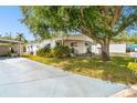 Inviting single-story residence with a large tree-shaded yard and extended driveway, offering ample outdoor space at 4803 Brae Burn Ave, Sarasota, FL 34234