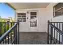 Charming front porch with decorative railing and patterned flooring, offering a cozy and inviting entrance at 4803 Brae Burn Ave, Sarasota, FL 34234