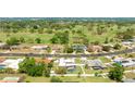 Lovely aerial view of the backyard pool and landscaping in a desirable neighborhood with a golf course at 504 Whitfield Ave, Sarasota, FL 34243