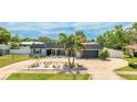 Charming single-story home boasts a beautiful front yard, mature palms, and well-maintained landscaping at 504 Whitfield Ave, Sarasota, FL 34243
