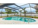 Relaxing screened-in pool area with a large pool and a peaceful outdoor setting at 504 Whitfield Ave, Sarasota, FL 34243
