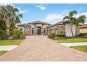 Beautiful single-story home with stone accents, a paver driveway and well-maintained landscaping at 5313 Greenbrook Dr, Sarasota, FL 34238