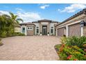 Beautiful single-story home with stone accents, a paver driveway and well-maintained landscaping at 5313 Greenbrook Dr, Sarasota, FL 34238