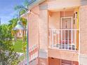 Elevated entry featuring a white-railed porch, textured walls, and a storm door with patriotic decor at 5500 Longwood Run Blvd # 201, Sarasota, FL 34243