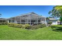 Spacious screened-in patio overlooking a large yard, ideal for entertaining and enjoying the outdoors at 626 Magellan Dr, Sarasota, FL 34243
