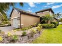 Side view of a charming single-story home with neutral stucco and well-maintained landscaping at 6492 Positano Ct, Sarasota, FL 34243