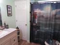 Cozy bathroom features a vanity, full shower/tub, and modern finishes at 705 Blackburn Blvd, North Port, FL 34287
