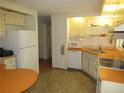 Functional kitchen featuring appliances, ample counter space, and neutral cabinetry for a cozy cooking environment at 705 Blackburn Blvd, North Port, FL 34287