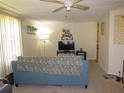 Inviting living room with neutral walls, comfortable seating, and a ceiling fan for added comfort at 705 Blackburn Blvd, North Port, FL 34287