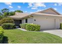 Charming home with manicured lawn and tile roof with an attached two-car garage at 7205 Wood Creek Dr # 16, Sarasota, FL 34231