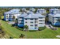 A luxury condominium boasts a manicured lawn, lush landscaping and a view of the community pond at 7810 34Th W Ave # 103, Bradenton, FL 34209
