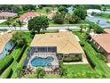 Aerial view of a home with a screened-in pool and spa surrounded by lush landscaping at 8449 Lone Eagle Way, Sarasota, FL 34241
