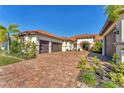 Elegant home with brick paver driveway, three-car garage and well-manicured landscaping at 909 143Rd Ne St, Bradenton, FL 34212