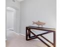 Entryway with light tile flooring, neutral walls, and a wood console table with a decorative fish at 9203 Griggs Rd # B102, Englewood, FL 34224