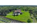 Scenic aerial view of a home with solar panels, lush greenery, and a long driveway at 1110 79Th E St, Palmetto, FL 34221