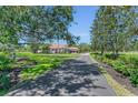 Long driveway to home with landscaped front yard at 1110 79Th E St, Palmetto, FL 34221