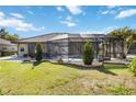 Backyard features a screened-in lanai and an in-ground pool, perfect for outdoor entertaining at 1118 Deardon Dr, Venice, FL 34292