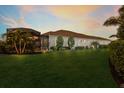 Expansive backyard with manicured lawn, lush tropical landscaping and screened-in patio at 16734 Collingtree Xing, Lakewood Ranch, FL 34202