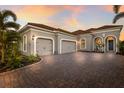 Charming home with a three-car garage, paver driveway, and beautiful landscaping at 16734 Collingtree Xing, Lakewood Ranch, FL 34202