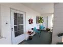 Welcoming condo entrance features stylish seating and a decorated front door at 1815 Restful Dr # N-27, Bradenton, FL 34207