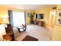 Bright living room with comfortable sofa, flat screen tv, and access to the outdoors at 1815 Restful Dr # N-27, Bradenton, FL 34207