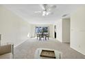 Open-concept dining area featuring a wooden table, three chairs, carpet, and natural light through sliding glass doors at 206 Elliot Ave # 137, Sarasota, FL 34232