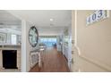 Condo entryway with shell-themed decor, hardwood floors, and an ocean view at 2675 Gulf Of Mexico Dr # 403, Longboat Key, FL 34228