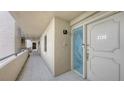 Condo hallway with neutral walls, tile flooring, and a decorative glass front door at 2675 Gulf Of Mexico Dr # 403, Longboat Key, FL 34228