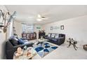 Bright living room with light-colored walls, ceiling fan, and contemporary furnishings at 270 E Langsner St, Englewood, FL 34223