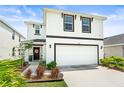Charming two-story home featuring a clean white exterior and well-manicured lawn, plus a two car garage at 3027 Great Abaco Way, Bradenton, FL 34208