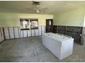 Spacious kitchen needing remodeling, with ceiling fan and natural light at 305 59Th St, Holmes Beach, FL 34217