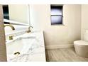 Bathroom featuring double vanity, marble countertop, and modern finishes at 3320 Riviera Dr, Sarasota, FL 34232