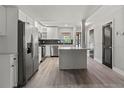 Bright kitchen with stainless steel appliances, white cabinets, and a modern backsplash at 3333 Ramblewood Pl, Sarasota, FL 34237