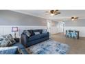 Spacious living room and dining area with tiled floors, ceiling fans, and a comfortable seating area with contemporary decor at 415 63Rd St, Holmes Beach, FL 34217