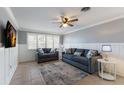 Cozy living room with plantation shutters, tiled floors, a ceiling fan, and comfortable seating area with contemporary decor at 415 63Rd St, Holmes Beach, FL 34217