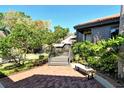 Well-maintained front yard with brick patio and lush landscaping, creating a welcoming entrance at 4375 Trails Dr # 17-1, Sarasota, FL 34232
