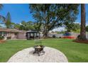 A spacious backyard featuring a fire pit, seating, and colorful kayaks creating an inviting outdoor space at 4619 20Th W Ave, Bradenton, FL 34209
