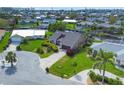 Aerial view features a home with manicured lawn, cul-de-sac street, and views of the surrounding neighborhood at 4704 Coral Lake Dr, Bradenton, FL 34210